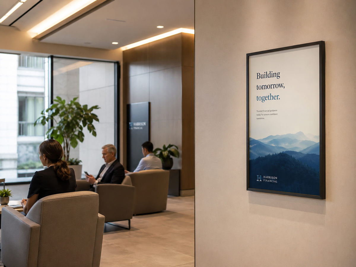 Deflecto A1 black snap frame hanging on a reception wall beside a seating area, displaying a large landscape poster