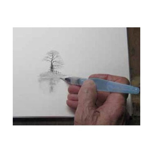 Hand working a water brush over a charcoal drawing of a tree on white paper, shown in the Derwent Charcoal pencil listing.
