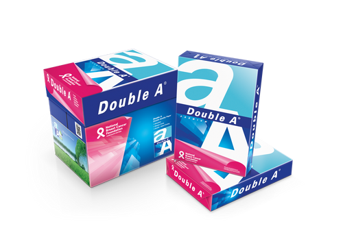 Double A A4 copy paper carton standing beside two wrapped reams, showing the blue and white Double A branding, the pink National Breast Cancer Foundation band and the green plantation photograph across the pack faces