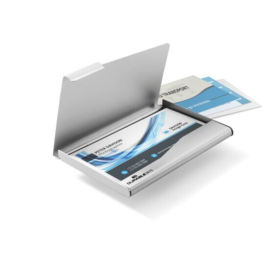 Open aluminium business card box with cards inside and more cards beside it