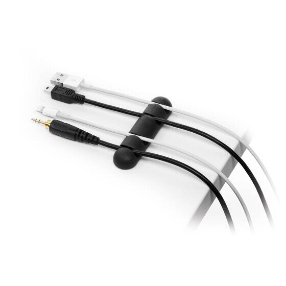 Durable graphite cable clip on a desk corner with USB and audio leads curving through its channels