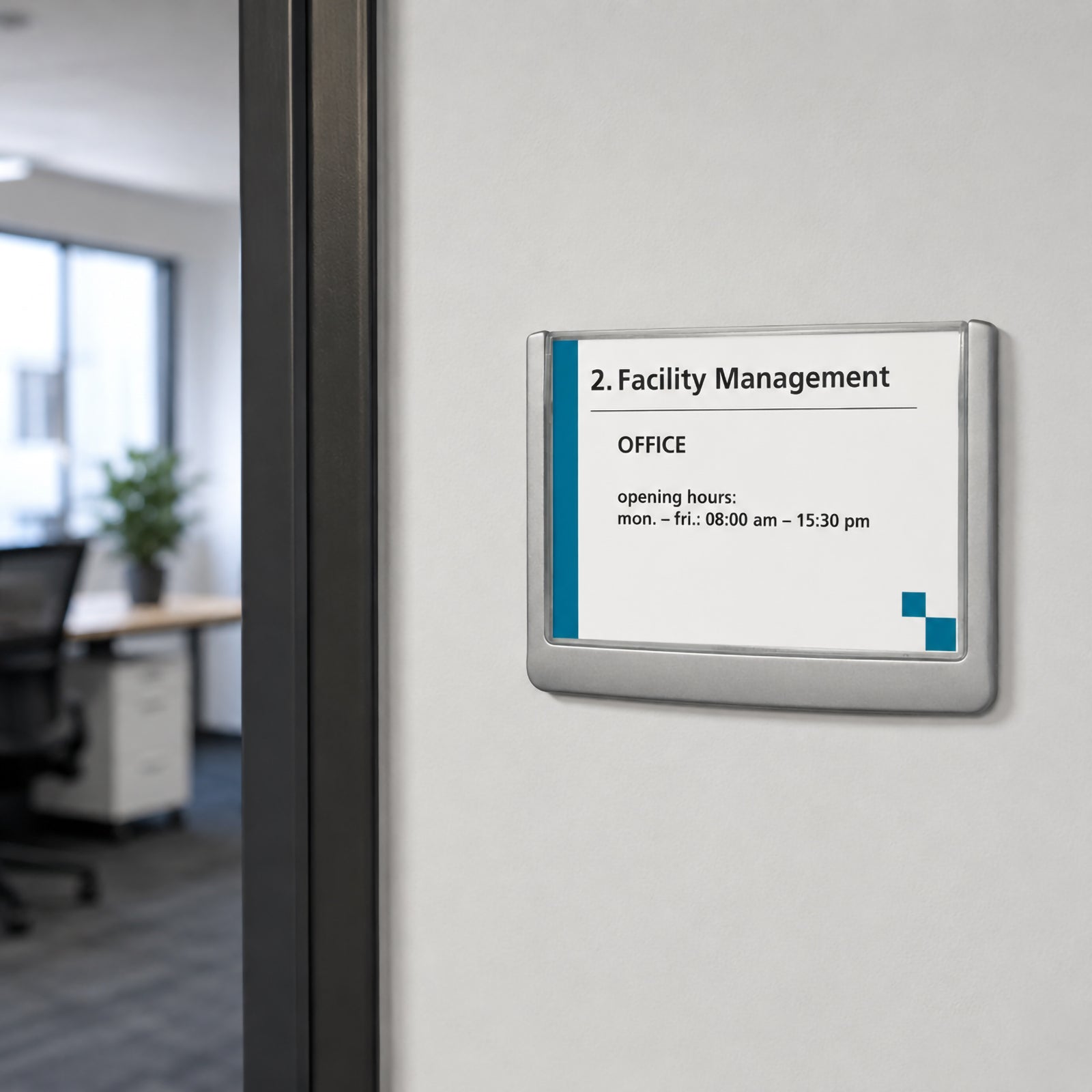 The Durable Click Sign 149 x 105.5mm Grey mounted neatly beside a modern office doorway. The sleek grey frame is installed on a clean white wall with a contemporary workspace visible in the background, illustrating its use for room identification and professional office signage.