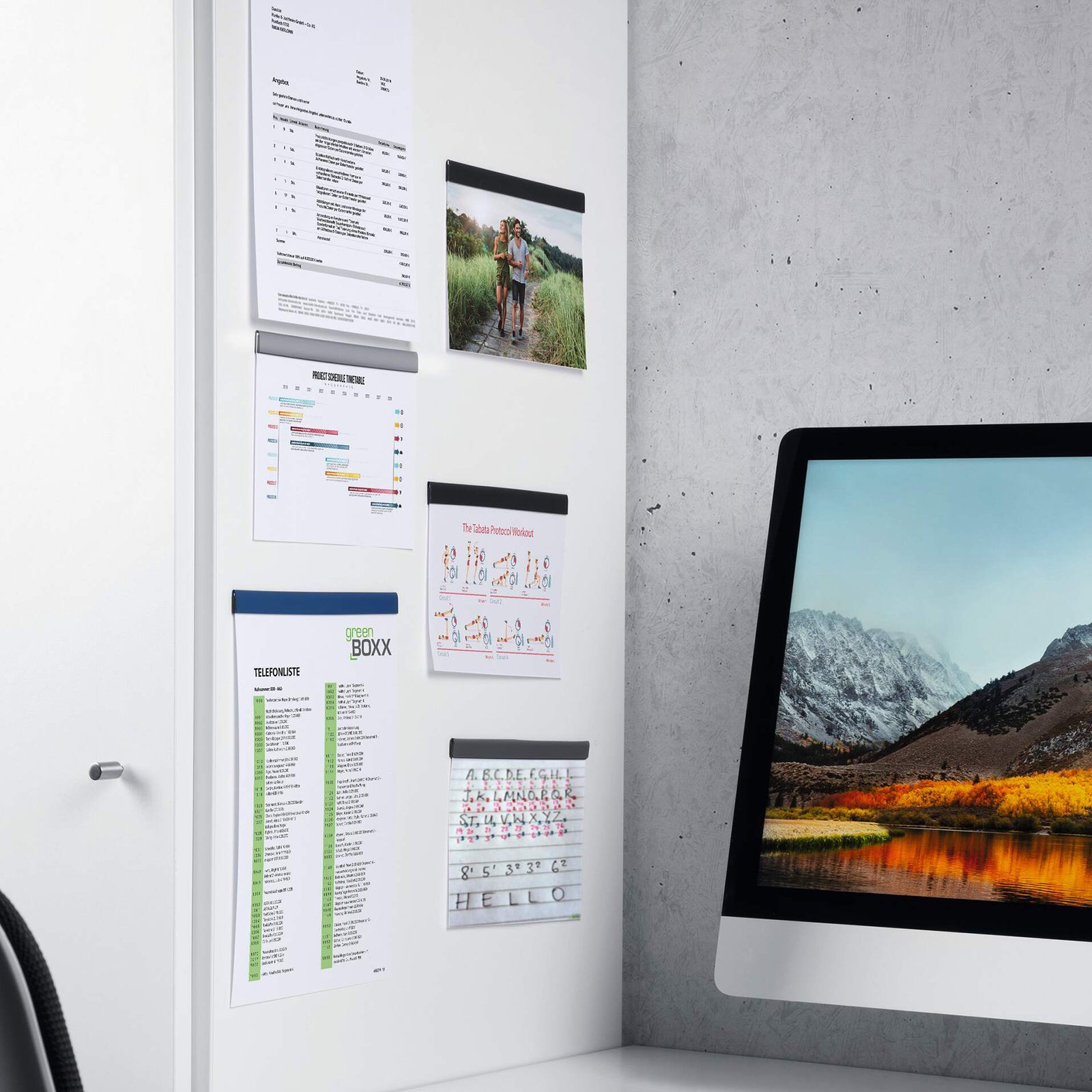 Durable Durafix 210 x 17 mm silver magnetic strips installed on a white office cabinet displaying project schedules, technical documents, reference sheets and photographs. The image demonstrates professional document organisation using multiple magnetic strips in a modern workspace.