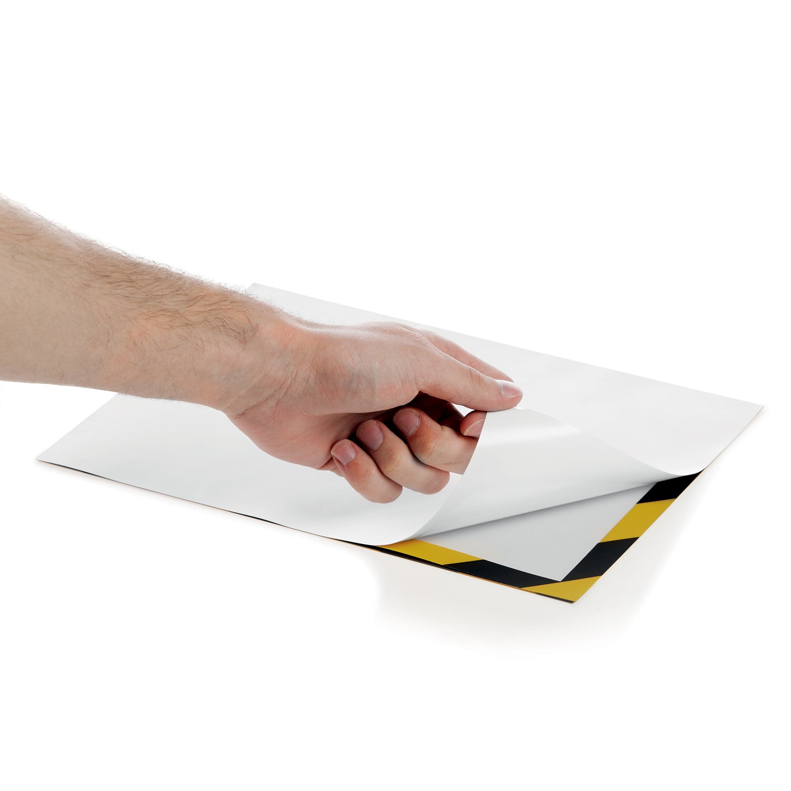 Close up showing the protective backing being peeled from the self adhesive rear of the Durable DURAFRAME Security frame before installation, highlighting the simple preparation process.