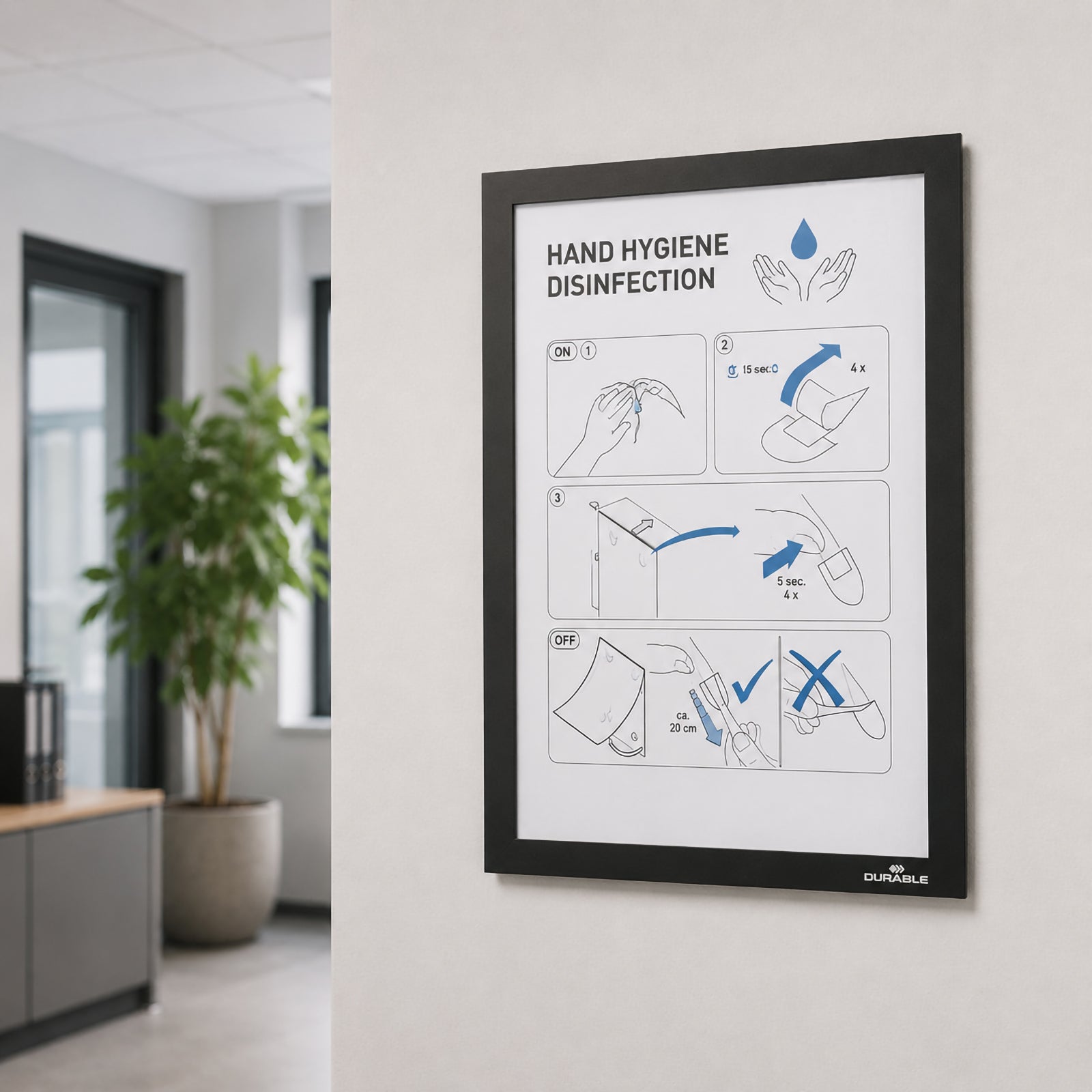 The Durable DURAFRAME Wallpaper A4 Display Frame mounted on a modern office wall displaying hygiene guidance. The clean black border complements the professional environment while illustrating its suitability for offices, healthcare facilities and commercial workplaces.
