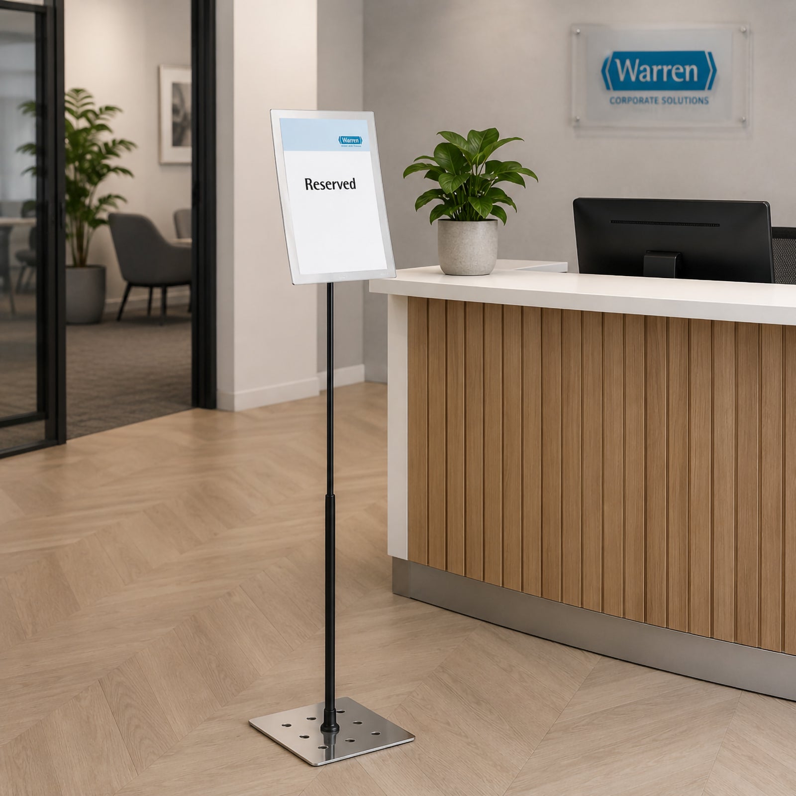 Wide office reception lifestyle image featuring the Durable Duraview Floor Stand A4 Silver placed near the reception counter with a reserved notice, illustrating its suitability for corporate offices, hotels and public reception areas.