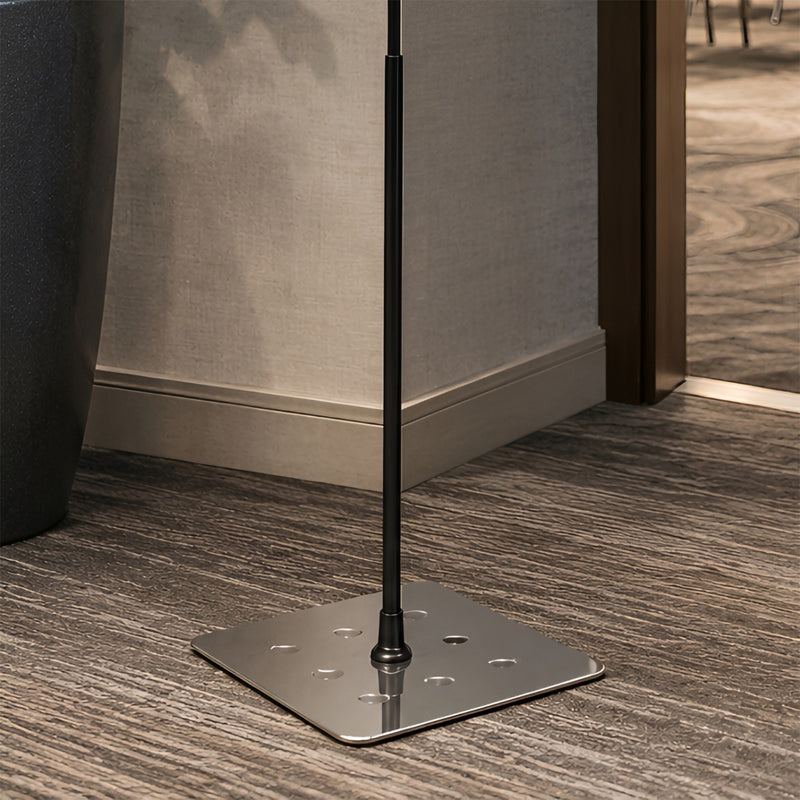 Close up of the Durable Duraview Floor Stand A4 Silver showing the robust square silver steel base with rounded corners and black support pole positioned on modern commercial flooring, highlighting the stable freestanding construction.