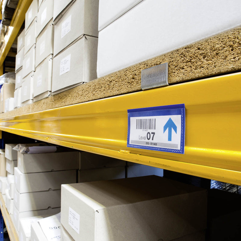 Single Durable Magnetic Document Pouch fixed to a warehouse shelf with a barcode location label clearly displayed. The compact dark blue holder provides professional shelf identification while protecting inserts from dust and wear.