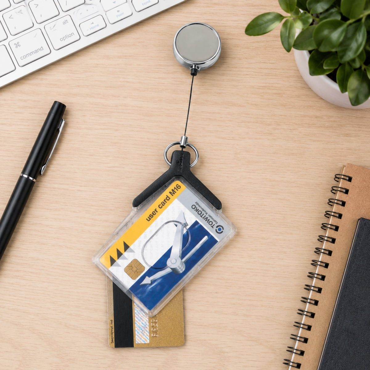 Durable Deluxe Pro Duo holder with two cards on a timber desk next to a keyboard, pen and spiral notebook