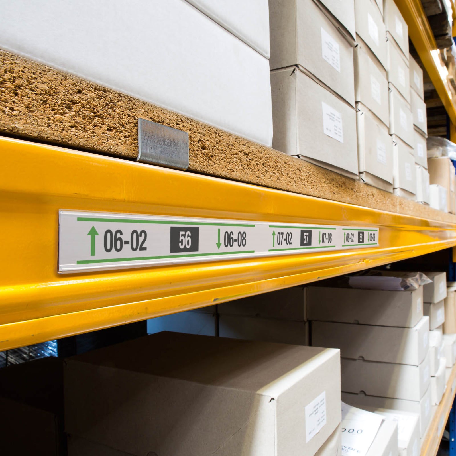 Angled warehouse shelving fitted with the Durable Scanfix Self Adhesive Label Strip, showing continuous rack labelling across multiple storage bays for organised inventory management and efficient stock retrieval.