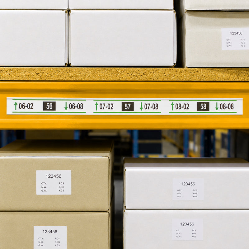 Front view of the Durable Scanfix Self Adhesive Label Strip installed on a yellow warehouse shelf beam displaying printed rack location labels and aisle identification beneath neatly stacked storage cartons.