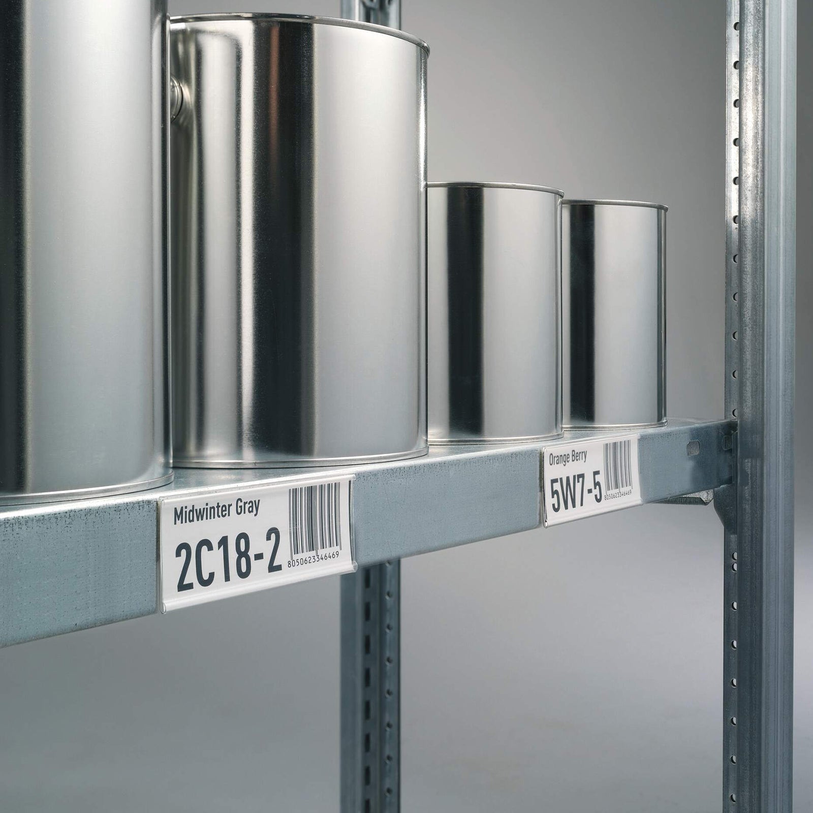 Industrial storage shelving fitted with Durable Scanfix Self Adhesive Label Strips displaying clear barcode and location labels beneath metal storage containers for organised inventory management and efficient stock identification.