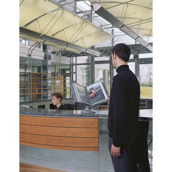 Visitor reading a SHERPA MOTION display on a reception counter