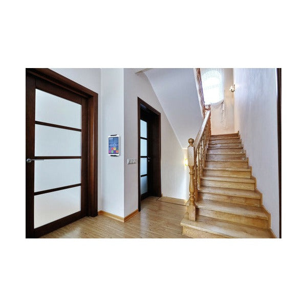 Hallway with a tablet in a wall holder beside a staircase