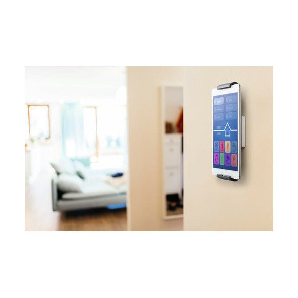 Close view of a tablet in portrait in a wall holder in a living area
