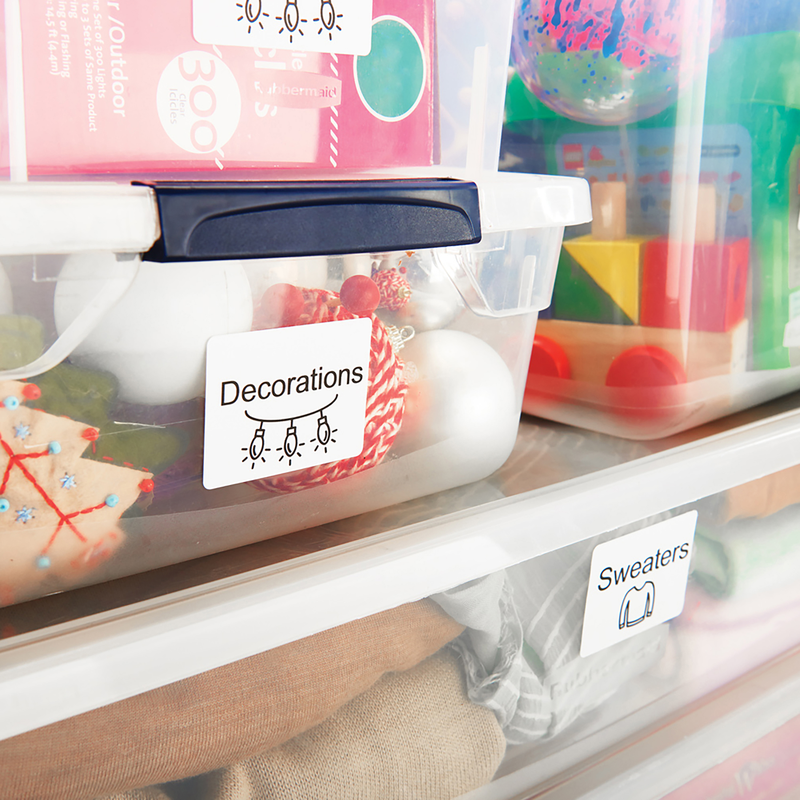 Storage tubs labelled Decorations and Sweaters with large Dymo labels