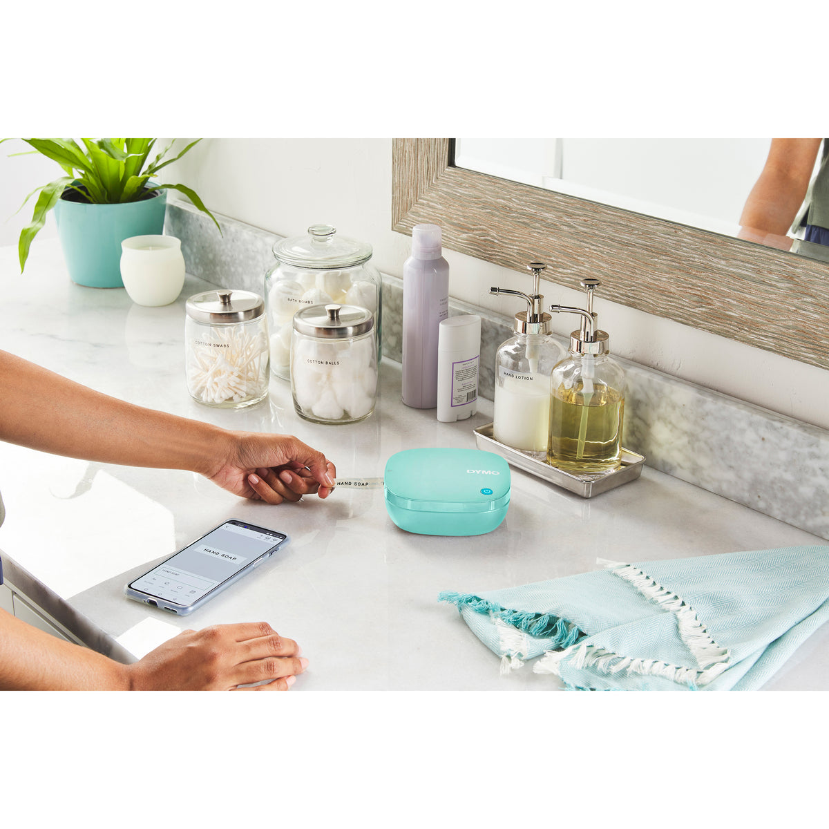 Blue LetraTag 200B on a bathroom bench with labelled jars and a phone