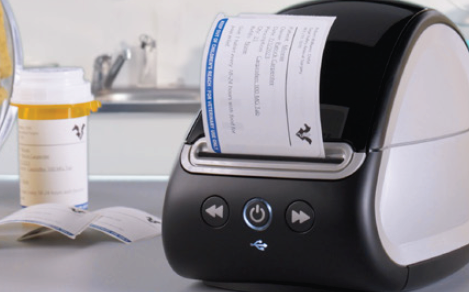 Dymo LabelWriter printer feeding out a printed veterinary prescription label carrying patient, medication and practice details.