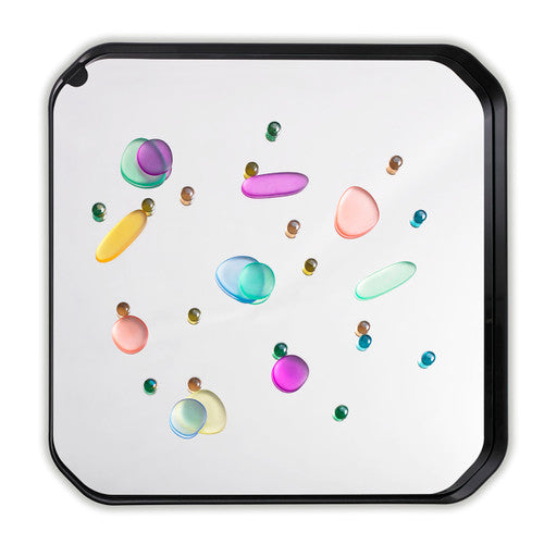 Rainbow pebbles arranged in a sorting pattern on a flat surface