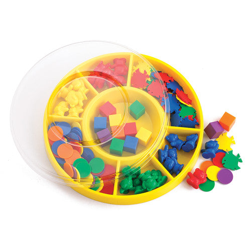 EDX Education First Sorting Kit with 132 colourful shapes, bears, and fish pieces spread around a circular sorting tray