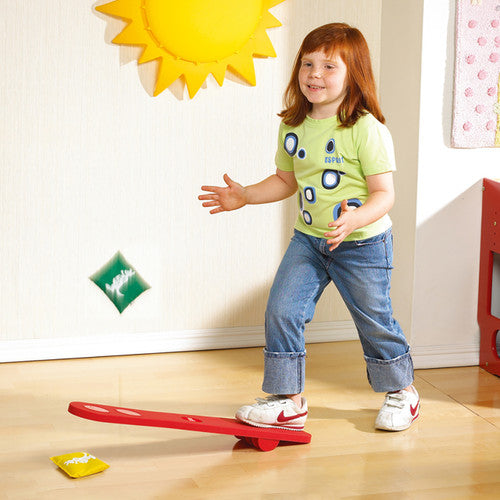 Child using the Joey Jumper board to launch a bean bag into the air