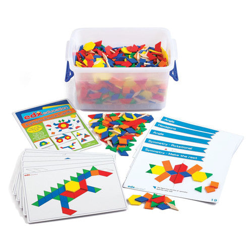 Six shapes and six colours of plastic pattern blocks spread out for classroom maths activity