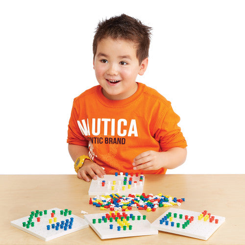 Child using the EDX Education Peg Board Set to create a colourful design on a white peg board