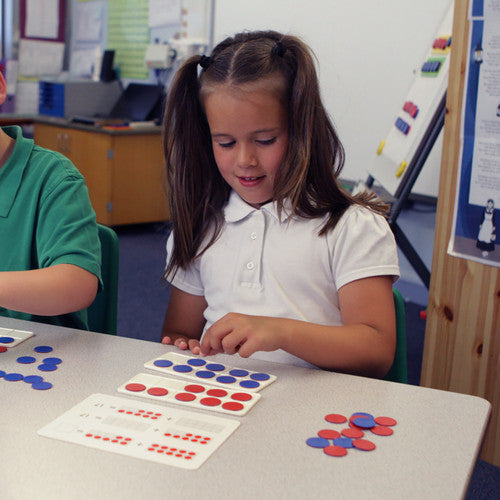 Child using ten frames and counters for hands-on early numeracy learning