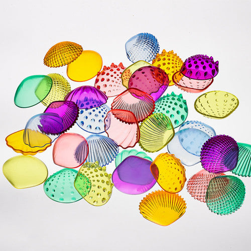 Child-sized 5.4cm transparent shells arranged by colour on a flat surface