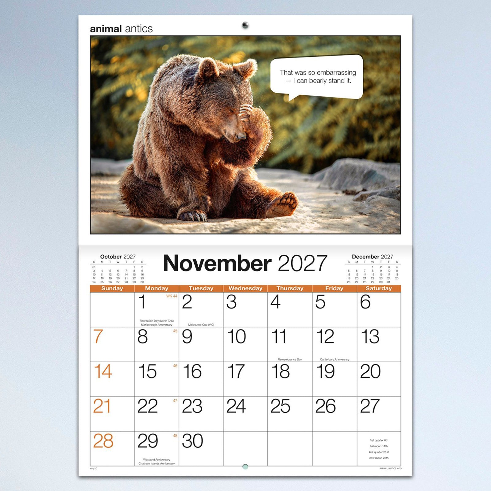 The November calendar page featuring a humorous bear photograph with a witty speech bubble above a spacious monthly calendar layout, offering plenty of room for appointments and reminders.