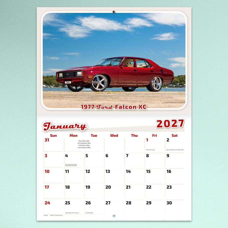 January page showcasing a polished red 1977 Ford Falcon XC beside the waterfront under a blue sky. The stitched calendar provides generous writing space while celebrating an Australian motoring icon.