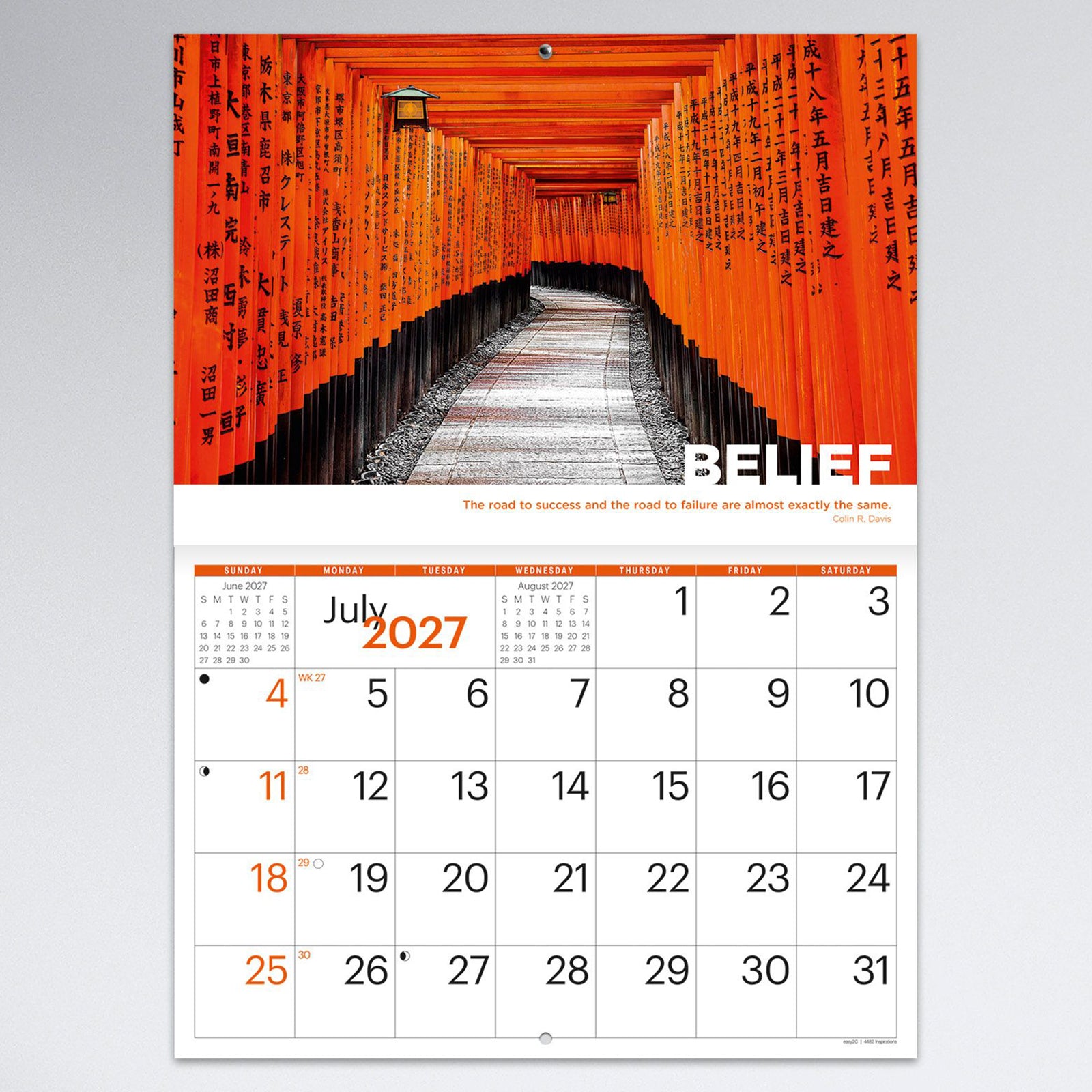 July monthly calendar page featuring a striking walkway of traditional orange Japanese torii gates under the theme Belief. The calendar combines memorable travel photography with generous planning space.