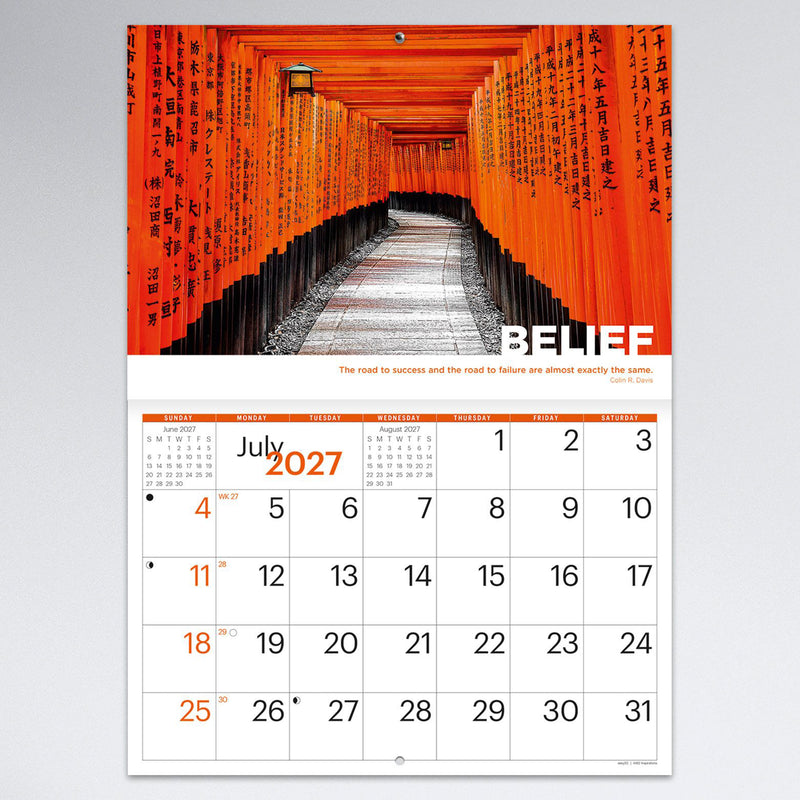 July monthly calendar page featuring a striking walkway of traditional orange Japanese torii gates under the theme Belief. The calendar combines memorable travel photography with generous planning space.