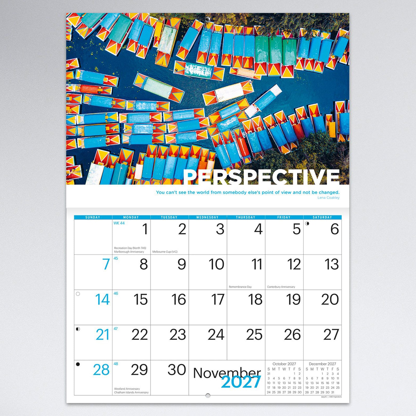 November monthly calendar page featuring an aerial view of colourful boats arranged across blue water with the theme Perspective. The spacious monthly grid provides room for planning while showcasing vibrant photography.