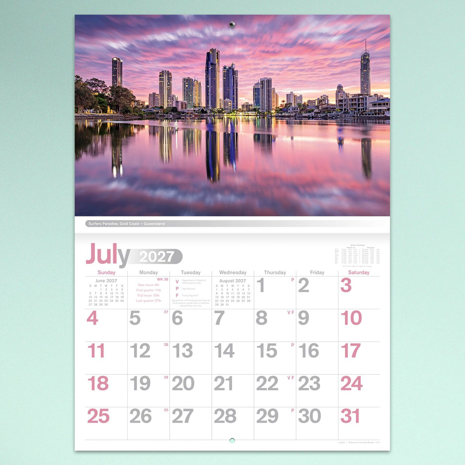 The July calendar page displaying the Surfers Paradise skyline at sunset with colourful reflections across the water above a clear monthly date layout.
