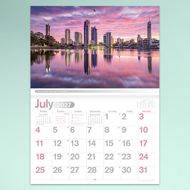 The July calendar page displaying the Surfers Paradise skyline at sunset with colourful reflections across the water above a clear monthly date layout.