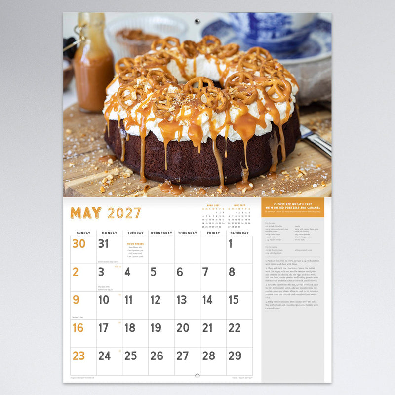 May calendar page showcasing a chocolate wreath cake with salted pretzels and caramel. The colourful recipe photography complements the large monthly planning section.