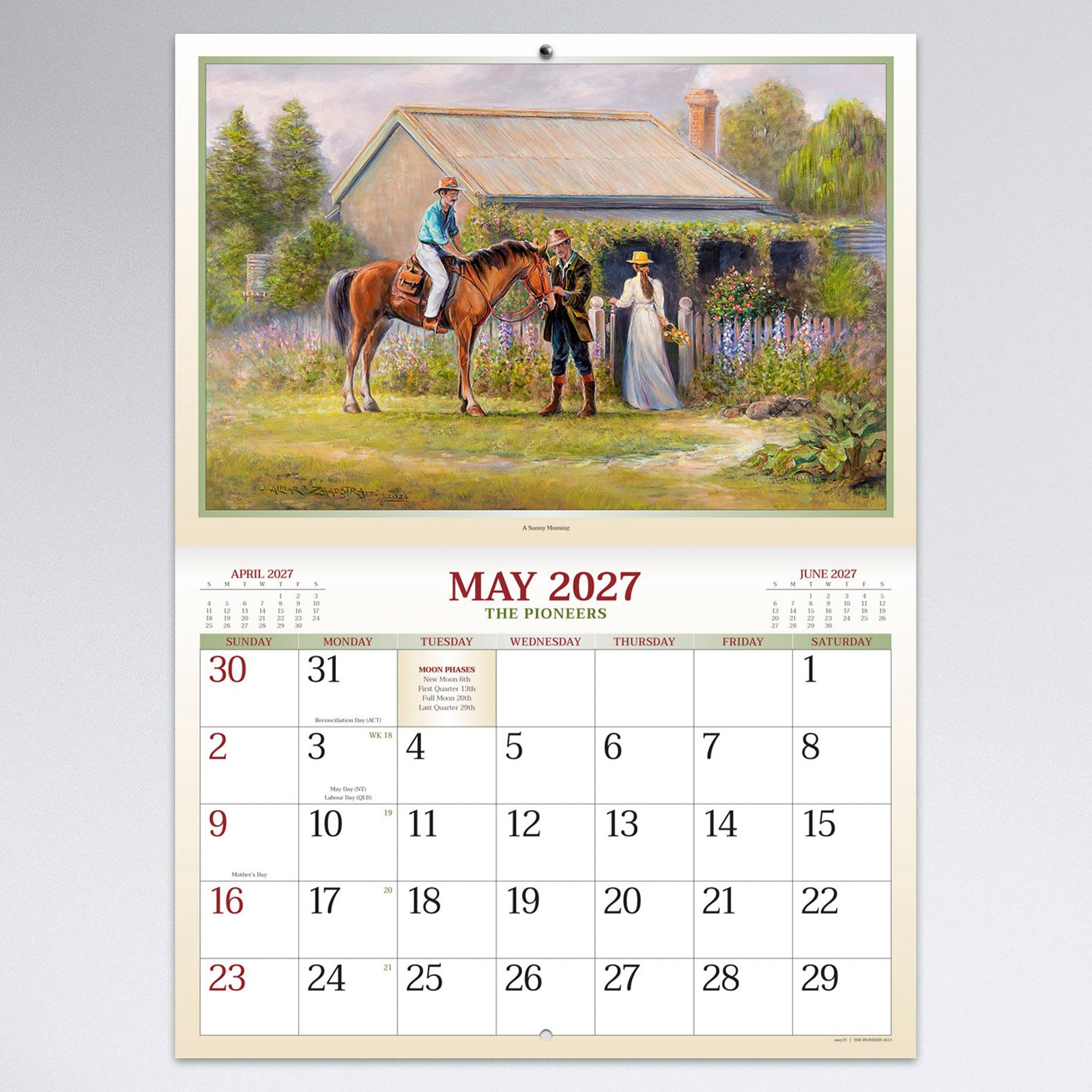May calendar page illustrating a peaceful rural homestead scene with horse riders and cottage garden above a spacious monthly planning calendar.