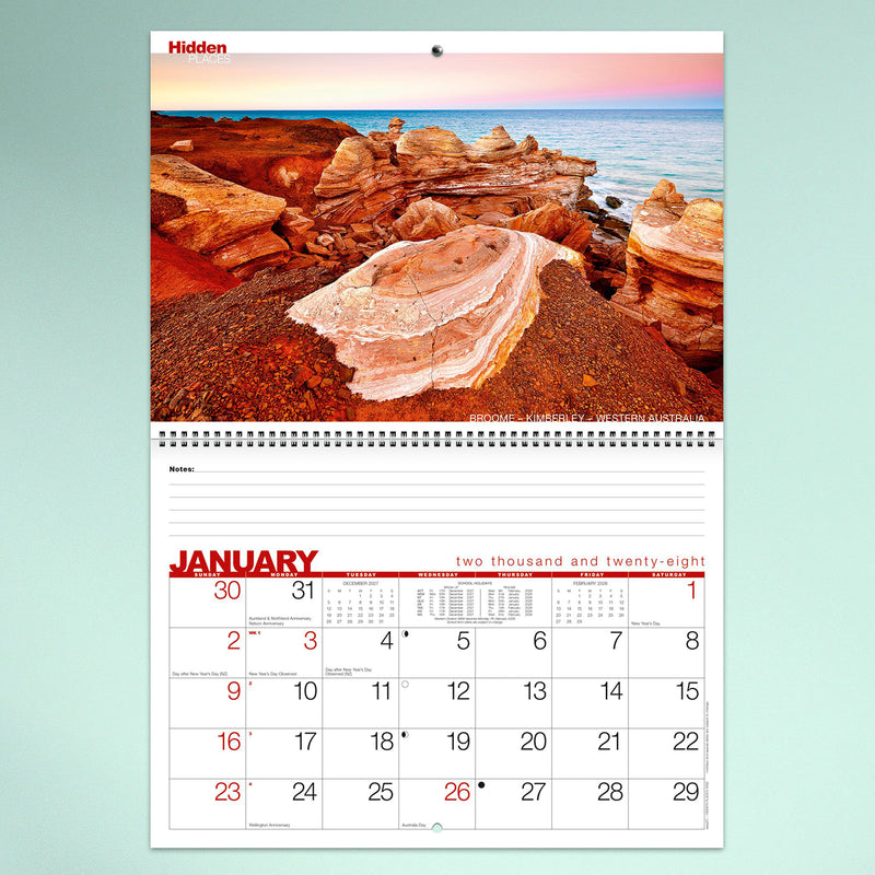 A monthly calendar page featuring dramatic red rock coastal formations from Broome in Western Australia. The landscape photography sits above a spacious monthly planner with lined notes section and bold red month heading.