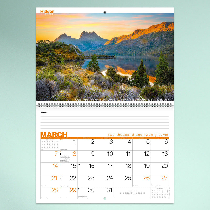 The March calendar page highlighting the iconic Dove Lake and Cradle Mountain in Tasmania during golden light. The premium print quality captures vivid colours while providing generous planning space below.