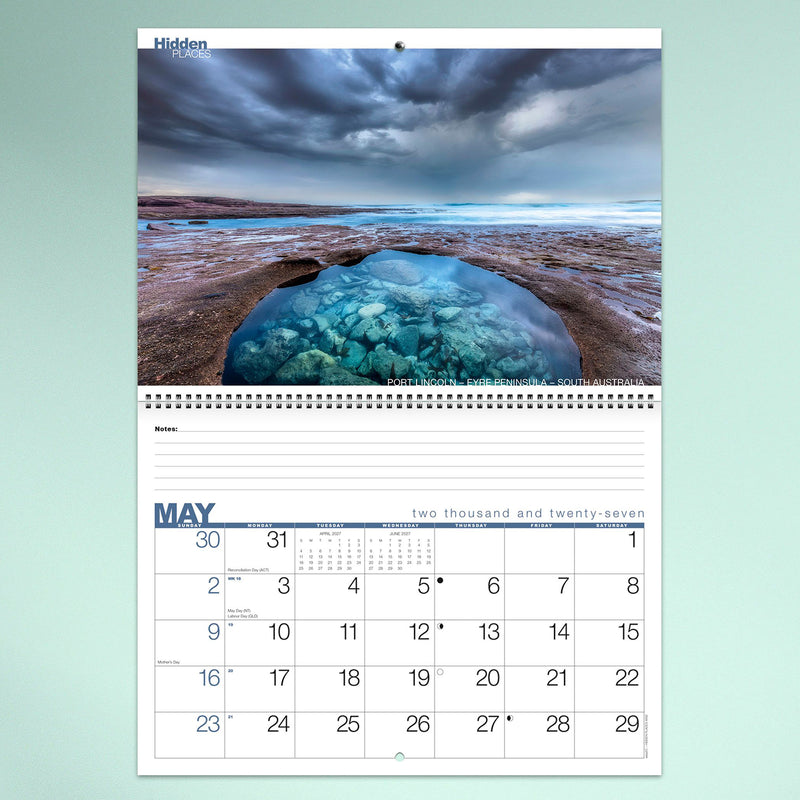 A May calendar page showcasing the famous blue rock pool at Port Lincoln on South Australia's Eyre Peninsula beneath dramatic storm clouds. The layout combines inspiring photography with functional monthly organisation.