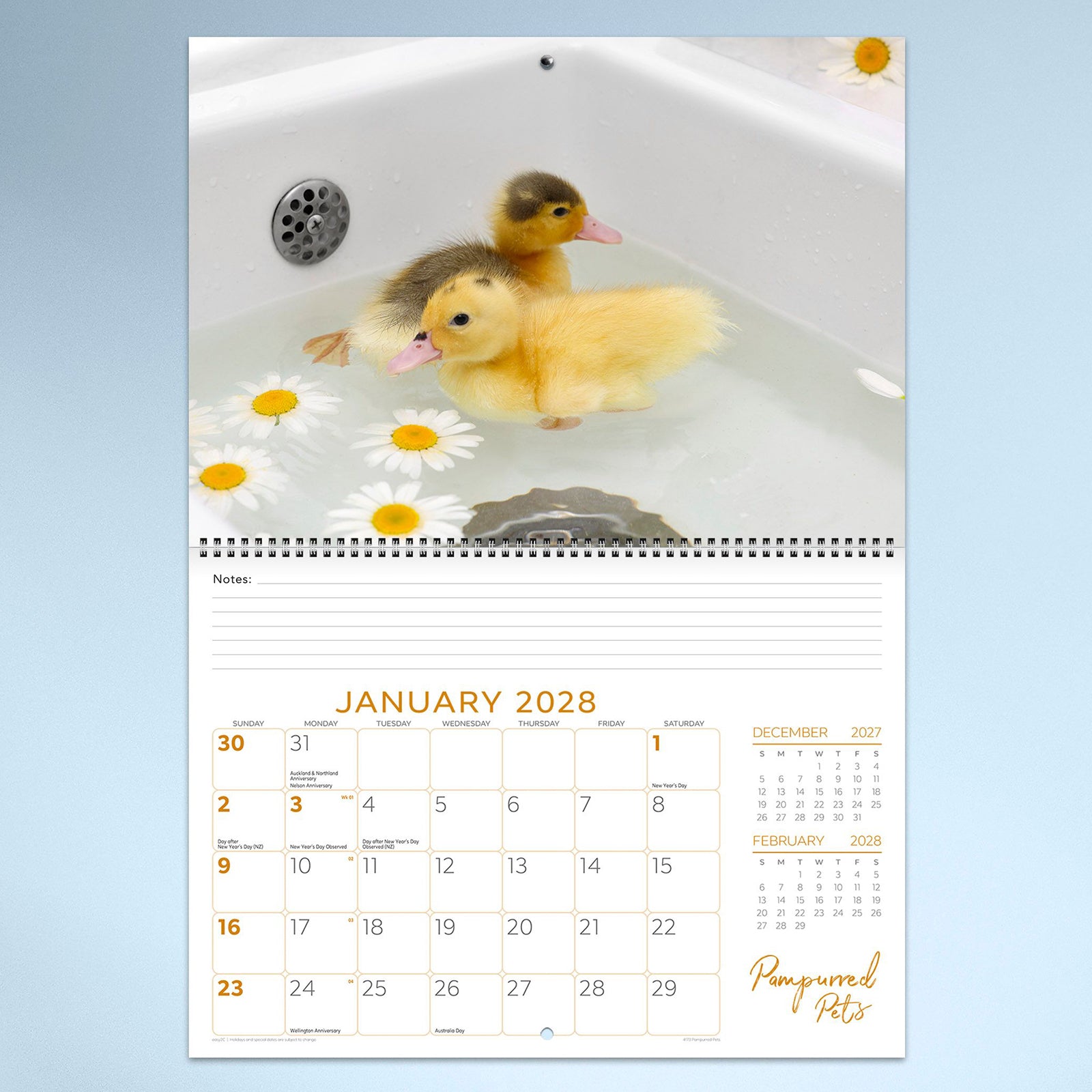 January 2028 calendar page featuring two fluffy ducklings enjoying a gentle bath surrounded by floating daisies. The cheerful image sits above a spacious monthly planning layout with notes section.