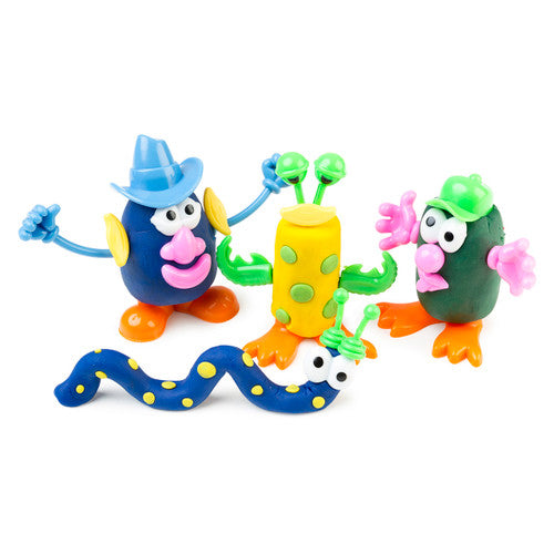 Child using Educational Colours Dough Characters accessories to decorate a handmade dough figure on a classroom table