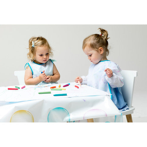 Child using the First Creations Messy Mat for painting and art activities