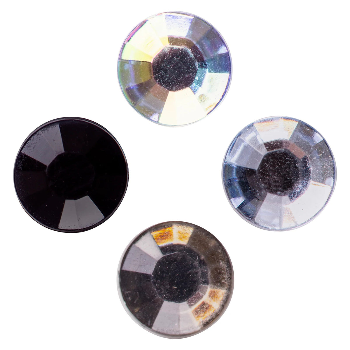 Close up view of four Educational Colours Mixed Adhesive Gems showing the faceted surfaces and contrasting reflective silver, smoky grey and dark tones included in the mixed silver craft assortment.