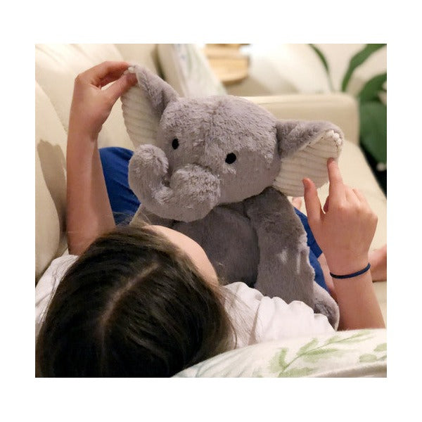 Weighted sensory elephant shown beside its reusable calico drawstring bag