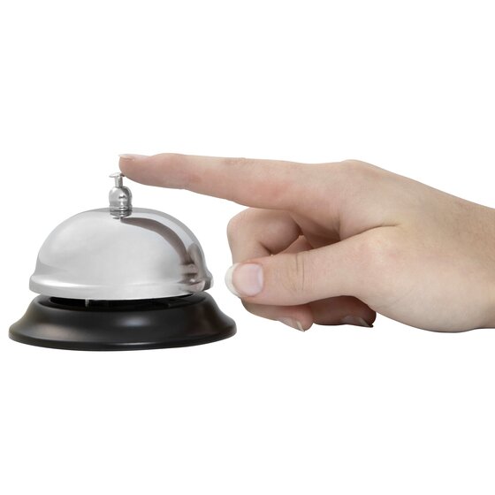 Finger pressing the plunger on top of an Esselte chrome and black counter bell