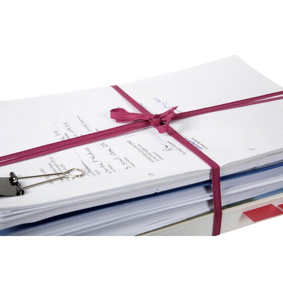 Stack of printed documents tied with pink legal tape finished in a bow, a bulldog clip on the side