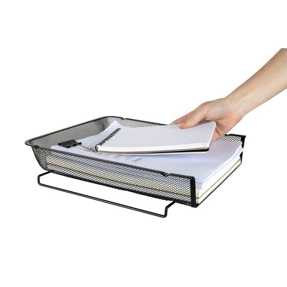 A hand placing a spiral notebook on a stack of paper in the black Esselte mesh tray