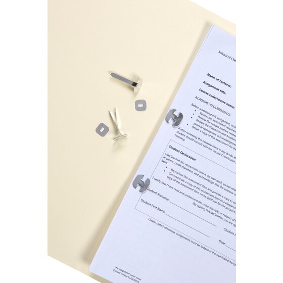 Esselte paper binders holding a punched document together on a cream manila folder